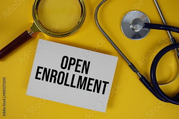 Obraz Open Enrollment text on paper card with Stethoscope flat lay on yellow background