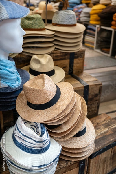 Fototapeta Stacks of straw  hats in hat store 