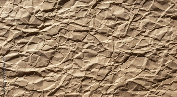 Fototapeta Crumpled brown paper texture provides a vintage and rustic background