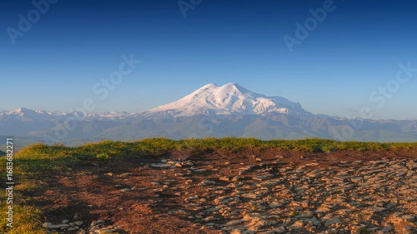 Fototapeta panoramic view of the Bolshoy Bermamyt plateau, with the snow-capped peaks of Mount Elbrus in the background, in early morning, at daytime, Stavropol Krai, Russia