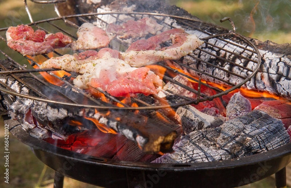 Fototapeta Bacon being grilled, outdoors