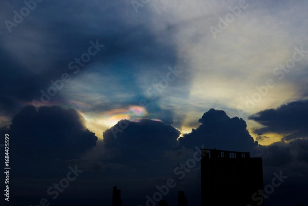Fototapeta Cloud iridescence or irisation over the dark sky. occurs when sunlight reflects off water droplets in the atmosphere.