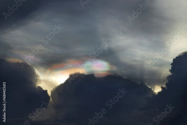 Fototapeta Beautiful Iridescent clouds over the dark sky. occur when sunlight diffracts off water droplets in the atmosphere.