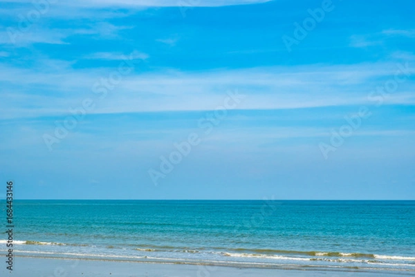 Fototapeta Nature of the ocean and blue sky Summer with sunshine, sandy beaches, clear blue waters sparkling against the blue sky. on an island with good ecology and environment Background for summer vacation
