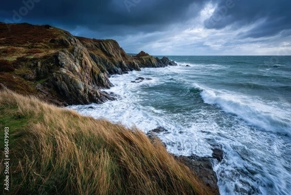 Fototapeta Stormy Coastal Landscape with Rugged Cliffs and Turbulent Sea