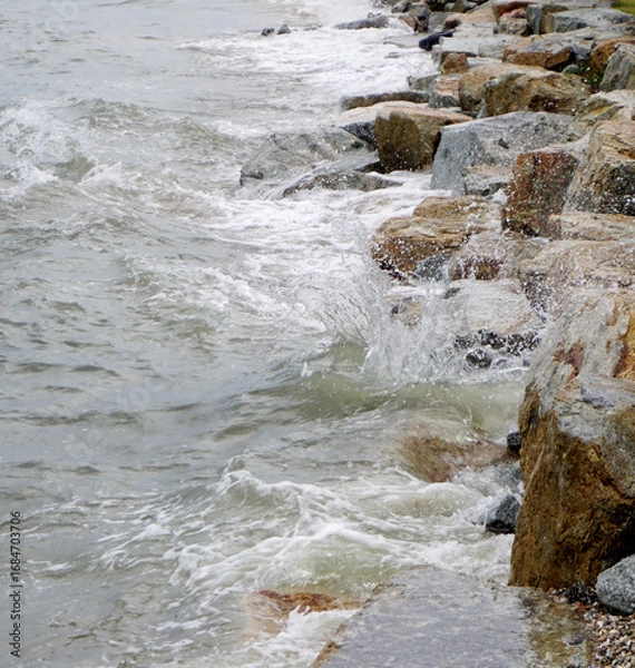 Obraz Splashing sea surf hitting rocks on the beach