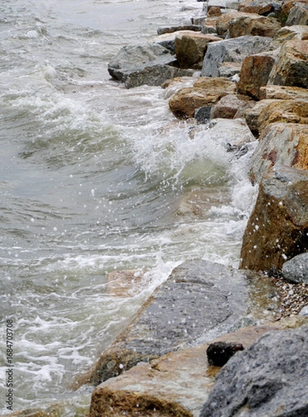 Obraz Splashing sea surf hitting rocks on the beach