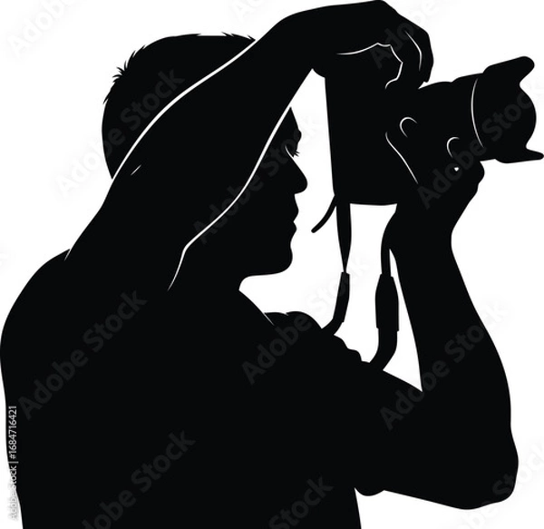 Fototapeta Silhouette of a photographer taking a picture, capturing a moment in time with passion and creativity