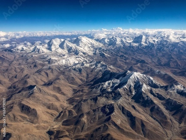 Fototapeta Aerial view of snowcapped mountain range