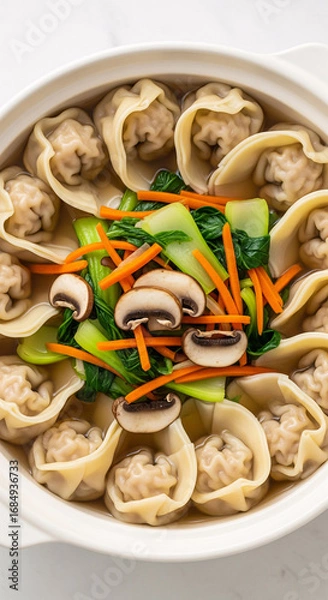 Fototapeta A bowl of wontons with a soup and vegetables
