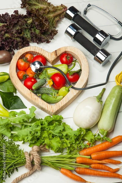 Obraz Fresh vegetables. Diet, a healthy lifestyle. Sport, dumbbells and a skipping rope on a white background