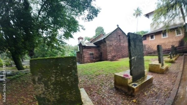 Obraz  Exterior view of the historic Chapel of St. Catherine, showcasing medieval architecture on a cloudy, rainy day
