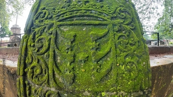 Obraz  Historic gravestone with intricate carvings and engravings displayed in the open area of the Chapel of St. Catherine, Old Goa