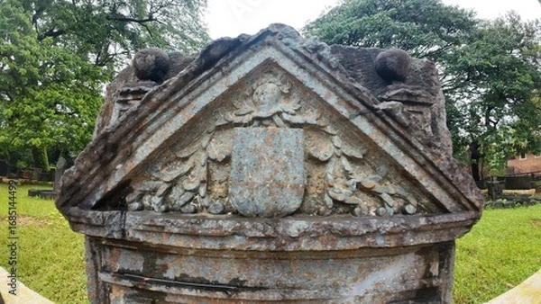Obraz  Historic gravestone with intricate carvings and engravings displayed in the open area of the Chapel of St. Catherine, Old Goa