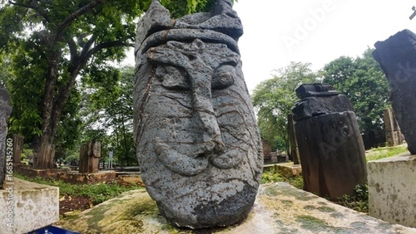 Obraz  Historic gravestone with intricate carvings and engravings displayed in the open area of the Chapel of St. Catherine, Old Goa