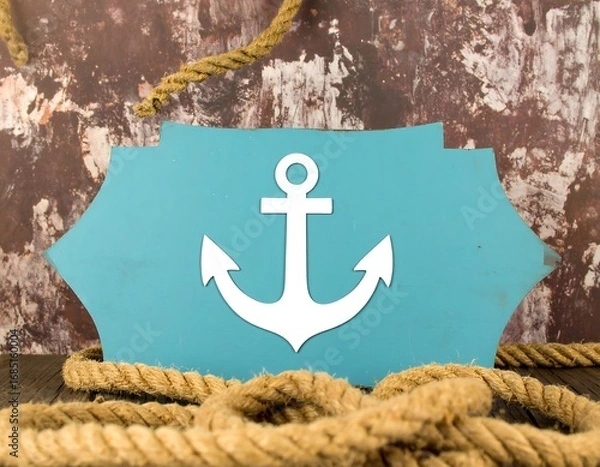 Fototapeta Teal sign with anchor design on weathered backdrop