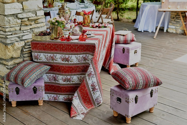 Obraz Outdoor picnic d cor on the outdoor veranda. The d cor is in the Armenian style, a tablecloth with grenades. White and red palette