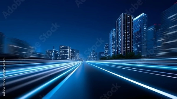 Fototapeta Blurred motion of an illuminated urban street at night, surrounded by a futuristic city skyline of modern skyscrapers and buildings