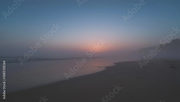 Fototapeta Misty Beach Sunrise with Fog Rolling Onto the Shoreline View
