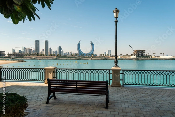 Fototapeta Doha, Qatar, Pearl Island the embankment in the city with a beautiful view and a bench.
