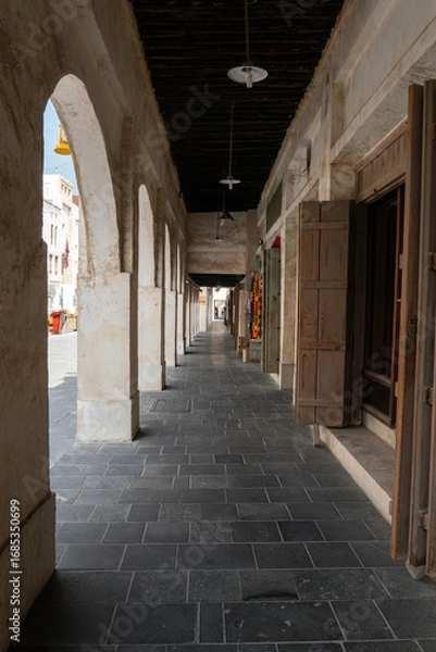 Fototapeta Traditional Qatari market with shops and storefronts, completely empty and without people. Historic Middle Eastern architecture and peaceful urban atmosphere.