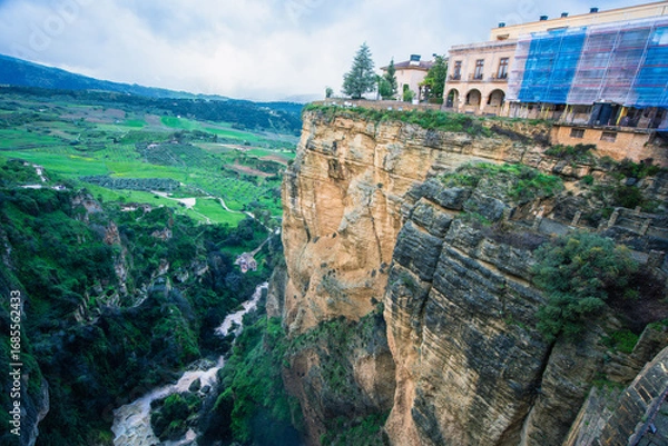 Fototapeta Dramatic view of Ronda Spain with cliffside buildings and deep gorge carved by Rio Guadalevin