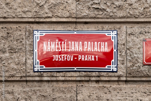 Fototapeta Náměstí Jana Palacha (Jan Palach Square) sign in Josefov Praha 1 in Prague, Czechia. Red colored road signage of the location in the so called Jewish Town. Square at the Rudolfinum building.