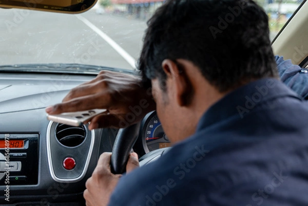 Fototapeta Distracted driver struggling to stay focused while driving
