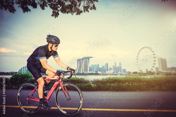 Obraz Man  exercising with bicycles outdoors
