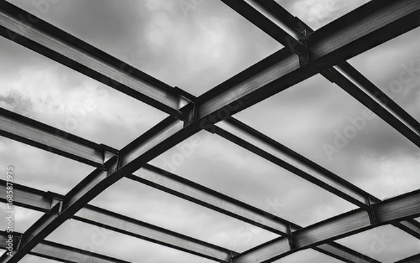 Fototapeta Intertwined steel beams form a complex architectural structure against a cloudy sky.