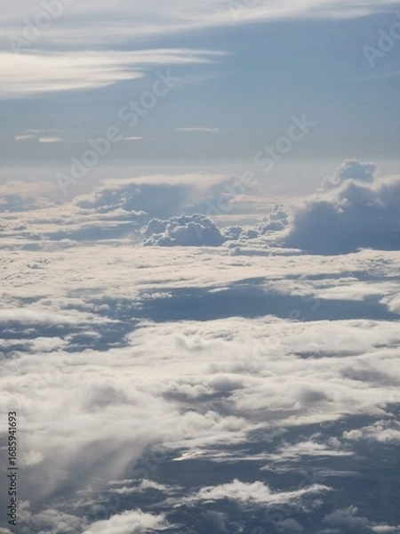 Fototapeta Expansive view of fluffy white clouds under a bright blue sky, showcasing the beauty of nature and the tranquility of the atmosphere, perfect for serene landscapes