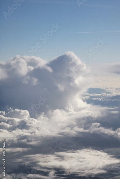 Fototapeta Expansive view of fluffy white clouds against a bright blue sky, showcasing the beauty of nature and the serenity of the atmosphere, perfect for relaxation and inspiration