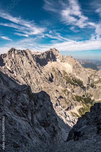Fototapeta Scenic View Of Zugspitze And Jubilee Ridge From Via Ferrata Alpspitze: Rugged Rocky Peaks Of The Bavarian Alps Under Clear Blue Sky