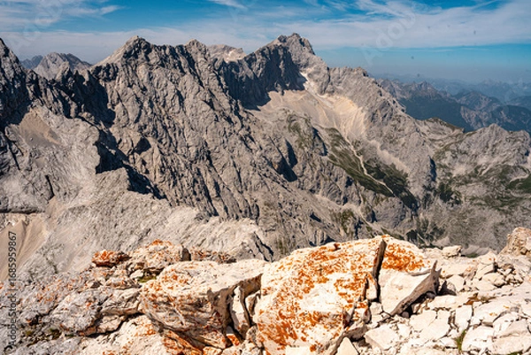 Fototapeta Scenic View Of Zugspitze And Jubilee Ridge From Via Ferrata Alpspitze: Rugged Rocky Peaks Of The Bavarian Alps Under Clear Blue Sky