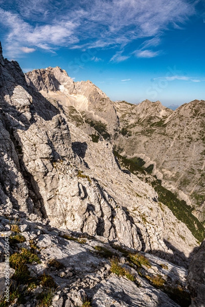 Fototapeta Scenic View Of Zugspitze And Jubilee Ridge From Via Ferrata Alpspitze: Rugged Rocky Peaks Of The Bavarian Alps Under Clear Blue Sky