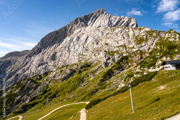 Fototapeta Rocky Section Of The Via Ferrata Alpspitze In The Bavarian Alps: Dramatic Cliffs And Mountain Peaks Under Scenic Blue Sky