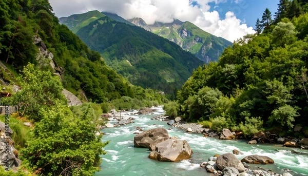 Fototapeta A vibrant landscape showcases a fast-flowing river winding through a lush, verdant valley
