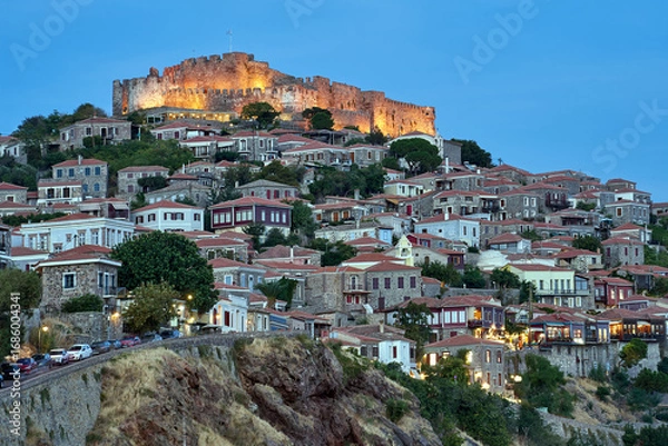 Fototapeta Historic houses and a castle on a hilltop in Molyvos on the island of Lesbos in the evening