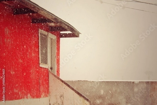 Fototapeta Red building in snowy weather, partially visible