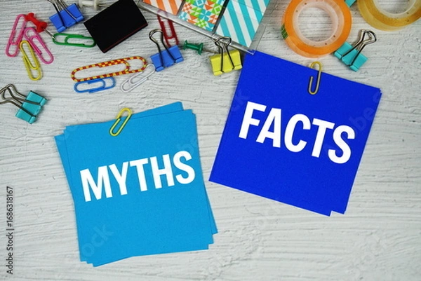 Obraz Myths vs Facts text on stick note with stationery on concrete background