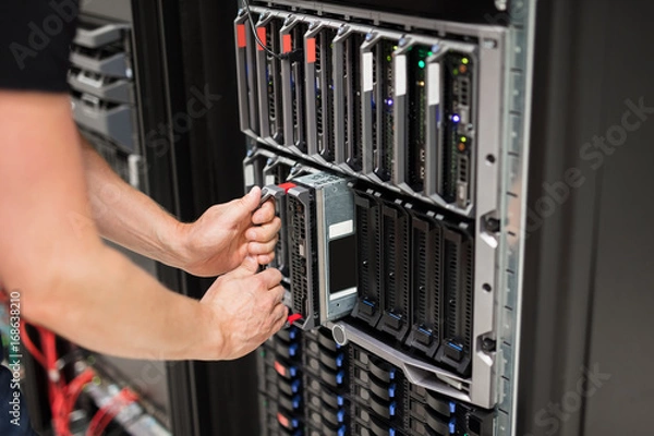 Fototapeta Computer Engineer Installing Blade Server In Data Center