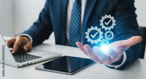 Obraz A businessman holds a glowing set of gears with checkmarks, symbolizing efficient processes and successful operations