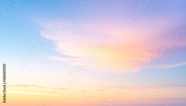 Obraz A tranquil sky at sunset with soft pastel clouds glowing in shades of pink and orange, blending beautifully with the blue sky, evoking calmness and peacefulness in a serene evening scene.
