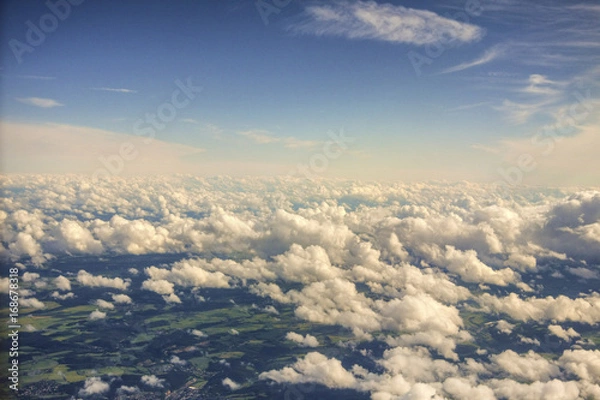 Fototapeta View from above the clouds. Flying over clouds in plane. Over clouds view.