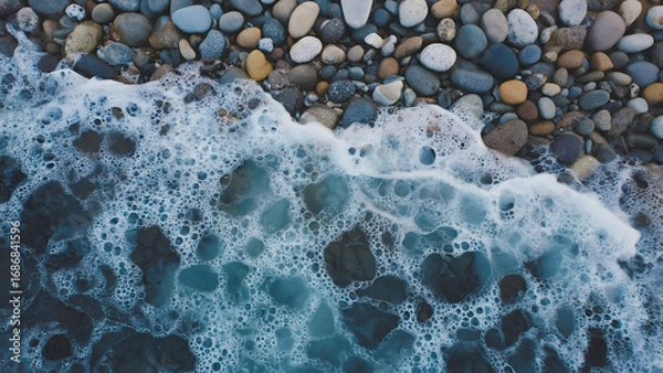Obraz Soothing aerial perspective of sea waves crashing on a tranquil stony shore