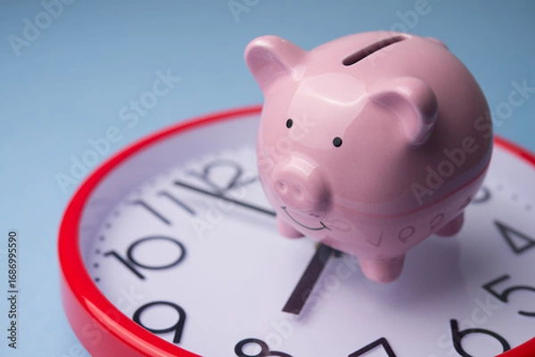 Obraz Pink piggy bank on clock background. Save money, money management, financial planning for investment or retirement, individual retirement account (IRA), passive income, dividend yield concept.