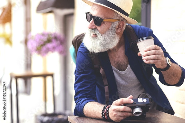 Obraz Cheerful mature tourist having break outside