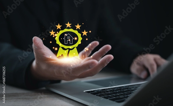 Fototapeta Hand holding digital award badge with house icon and five stars. Concept of real estate excellence, property recognition, quality assurance, best service, and high-value housing achievement.