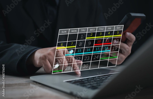Fototapeta Business executive using laptop with digital calendar interface. Concept of schedule planning, event organization, productivity, and effective time management for corporate work.