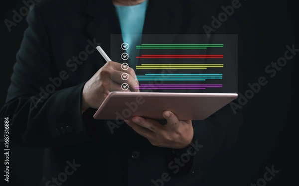 Fototapeta Entrepreneur completing digital checklist on tablet with colorful progress bars and stylus. Concept of productivity, task management, project tracking, and electronic workflow efficiency.
